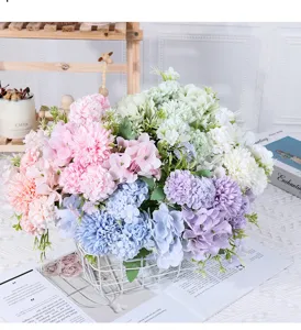 Detailed view of a mixed artificial flower bouquet in a white wire basket for decor