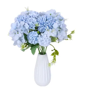 Elegant blue artificial hydrangea and pompon bouquet in a white ribbed vase for wedding