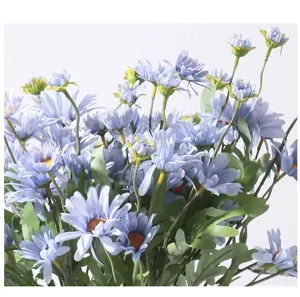 Close-up of delicate light blue artificial daisies for elegant floral home decoration.