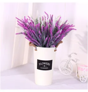 Detail of purple and white flocked artificial lavender in a rustic garden vase