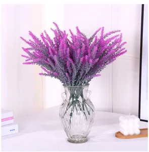 Detailed view of purple flocked artificial lavender in a stylish glass vase