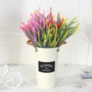 Colorful five-fork flocked artificial lavender plants in a rustic white metal flower bucket