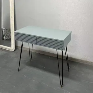 Detailed view of sage green vanity desk featuring two drawers and black hairpin metal legs