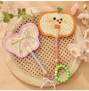 Handcrafted mini woven fan charms with pumpkin and butterfly designs for bag decoration.