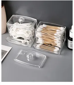 Detail macro view of transparent acrylic cotton swab and floss pick storage boxes