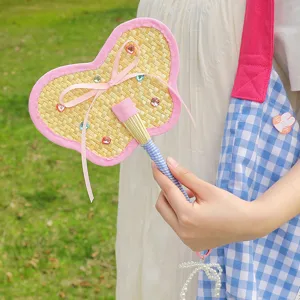Handmade butterfly-shaped woven straw fan with pink bow and pearl charm pendant