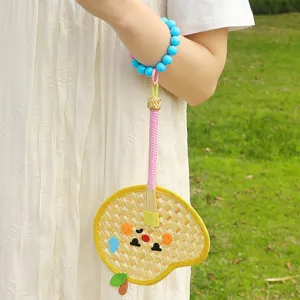Handmade mini woven palm leaf fan bag charm with cute cartoon fruit design for summer