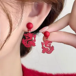Macro detail shot showing the matte red dragon design of these festive drop earrings