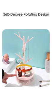 Close-up of a pink rotating tree branch jewelry organizer rack for earrings and necklaces.