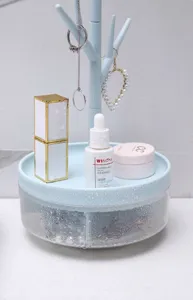 Close-up of waterproof light blue rotating tree jewelry storage rack with water droplets