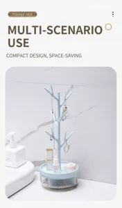 Detail view of a blue tree-shaped jewelry organizer on a white vanity countertop