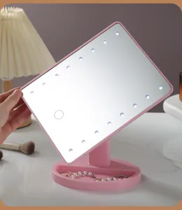 Detailed view of pink desktop LED makeup mirror with touch button and storage base