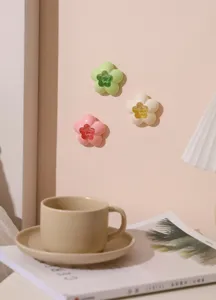 Detail view of flower-shaped air freshener boxes mounted on a pink wall for home decor.