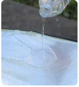 Detail view showing the waterproof surface of a silver heat-resistant scooter seat cover