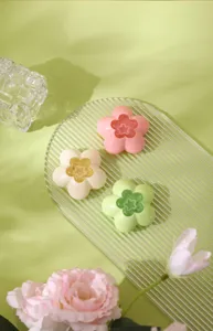 Pastel pink green and cream flower-shaped air freshener containers for home bathroom decor