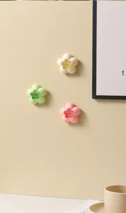 Detail view of flower-shaped gel air fresheners on a bathroom wall for odor removal