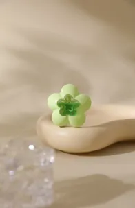 Close-up view of the cute green flower-shaped air freshener box for car or bathroom