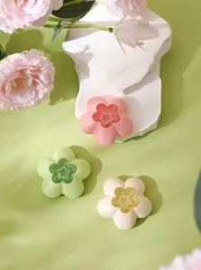 Detailed view of flower-shaped air freshener holders in pastel colors on display blocks