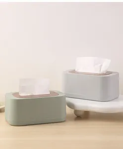 Two minimalist Nordic style tissue boxes with wood lids in sage green and light gray