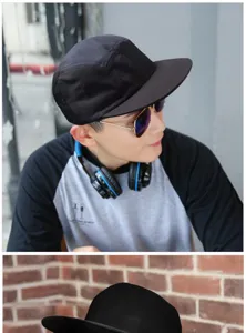 Detail view of a men's black five-panel skateboarding cap featuring a modern flat brim design