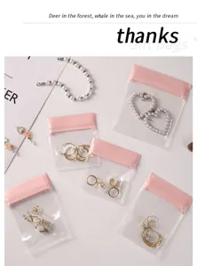 Detail of transparent pink EVA jewelry storage bags with assorted earrings and rings