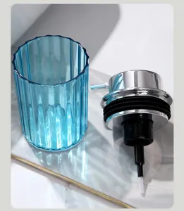 Detailed view of the blue ribbed foam dispenser bottle and chrome pump mechanism