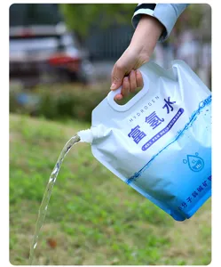 Hand pouring water from a 5L portable foldable water storage bag in outdoor setting.