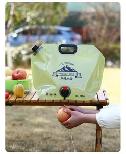 Portable 8L collapsible outdoor water bag with tap being used to wash fruit outdoors.