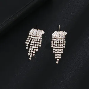 Detailed view of elegant drop earrings featuring shimmering crystal tassels and baguette gems