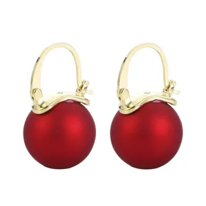 Elegant gold-tone hoop earrings with large matte red spherical pendants for women.