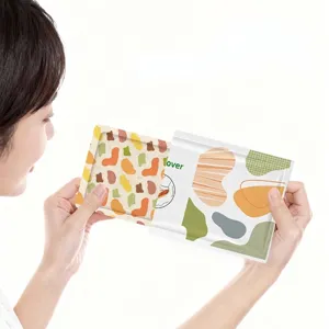 Disposable self-heating foot patch with artistic pattern held by model for use