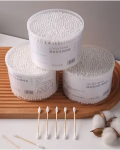 Detailed view of disposable double-headed cotton swabs in jars for makeup and ear care