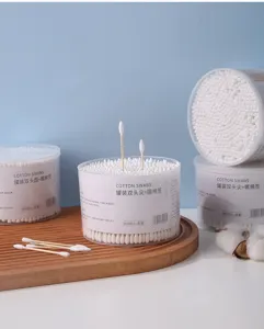 Detailed macro shot of disposable double-headed cotton swabs in clear plastic jars