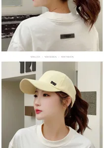 Detailed side view of a cream high ponytail baseball cap featuring DYJ embroidery for women