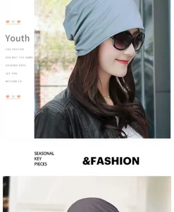 Model wearing a light blue slouchy knit beanie hat with sunglasses and leather jacket