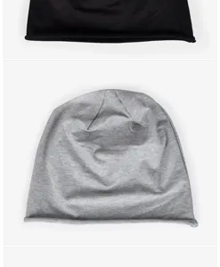 Detailed macro view of light gray cotton rolled-edge beanie with soft knit texture