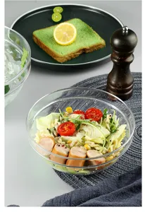 Macro view of a clear acrylic salad bowl filled with fresh vegetables and sausage