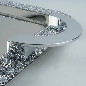 Close-up of luxury stainless steel tray with crushed diamond rim and polished handle