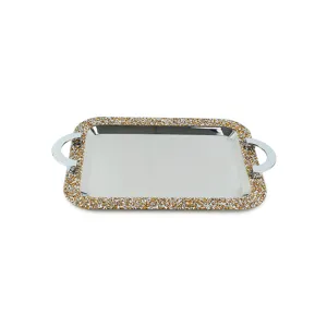 Detailed view of rectangular stainless steel tray with sparkling rhinestone border and handles