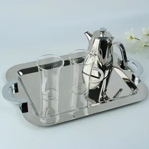 Elegant rectangular stainless steel tray set with crystal handles, teapot, and clear glassware.