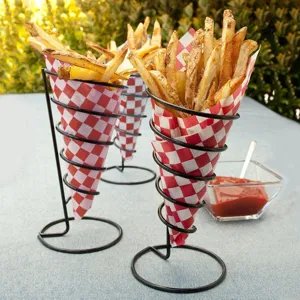 Red and white checkered greaseproof paper wrapping french fries in a cone stand.