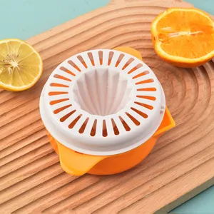 Portable manual citrus juicer for orange and lemon with fresh fruit on wood board