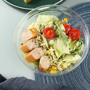 Large durable transparent acrylic salad bowl containing fresh pasta and sausage salad