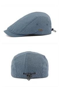 Close-up detail of blue textured checkered flat cap with adjustable drawstring closure