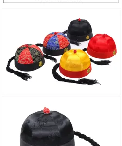 Close-up and collection of traditional vintage Chinese silk skullcap hats with braids.