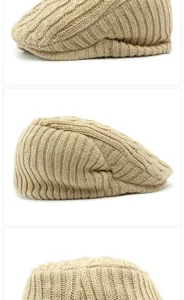 Close-up macro view of the thick cable-knit texture on a beige winter beret flat cap