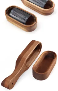 Detailed view of the acacia wood base and black stainless steel cheese grater set.