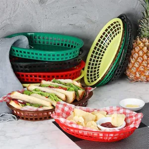 Multicolor plastic fast food baskets filled with sandwiches and chips in a restaurant setting
