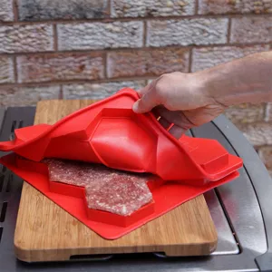 Detail eines roten Silikon-Burger-Formers mit sechseckigen Fleisch-Patties