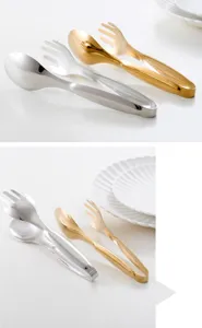 Detailed view of gold and silver stainless steel food tongs with fork and spoon head